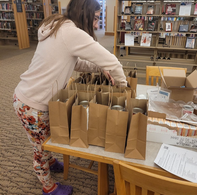 Teen girl filling paper bags