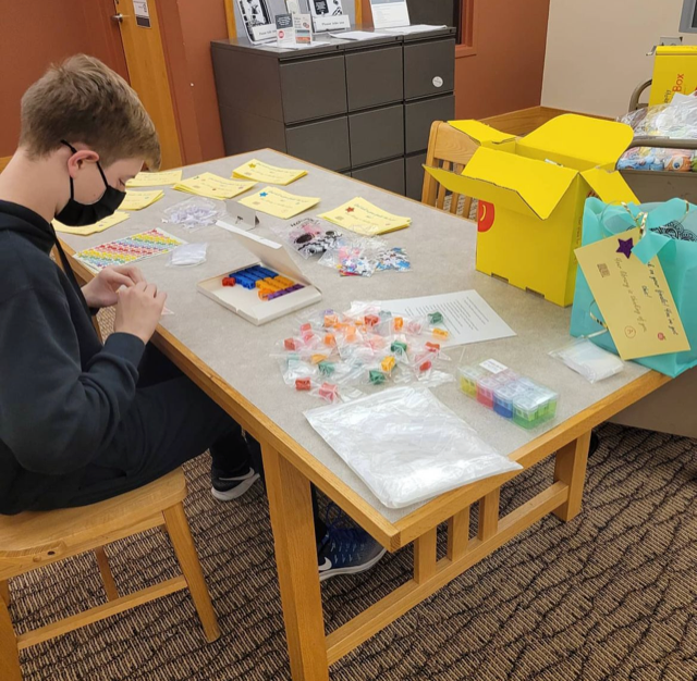 Teen boy packing supplies for a program