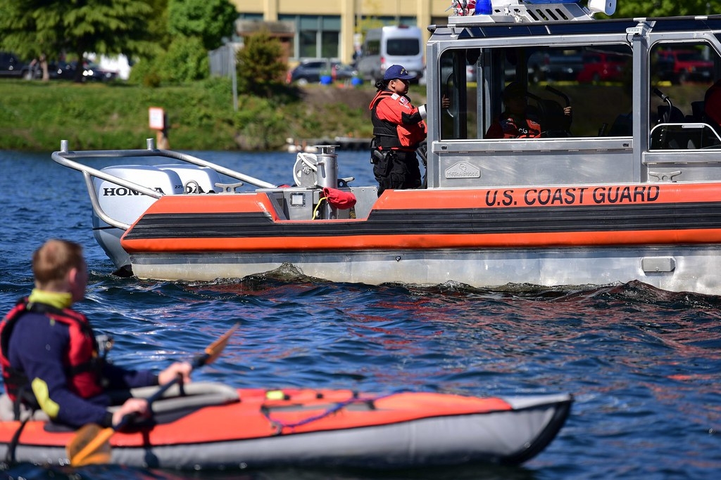 Person in red paddle boat on water