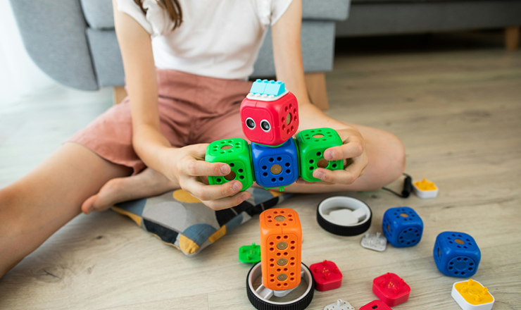 Girl playing with a robotics STEM set