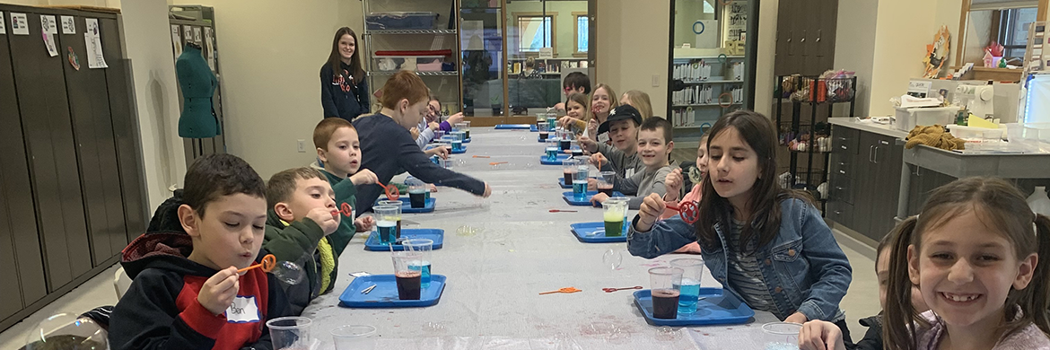 Mad Science Lab program image showing children at a long table